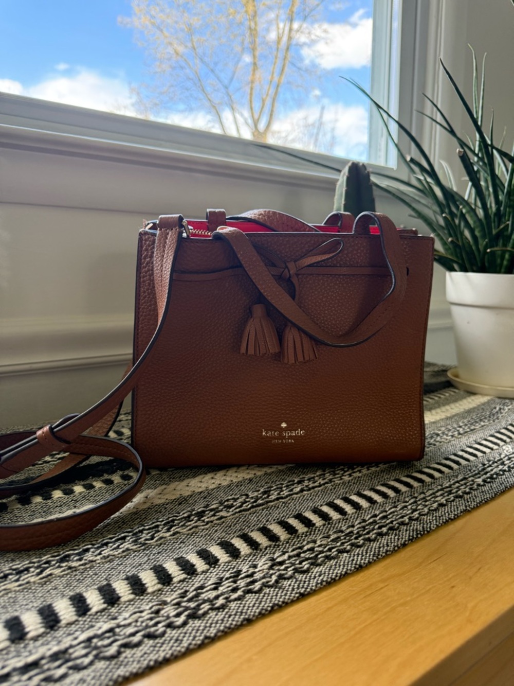 kate spade brown pebbled leather satchel with red interior trim & tassel accents
